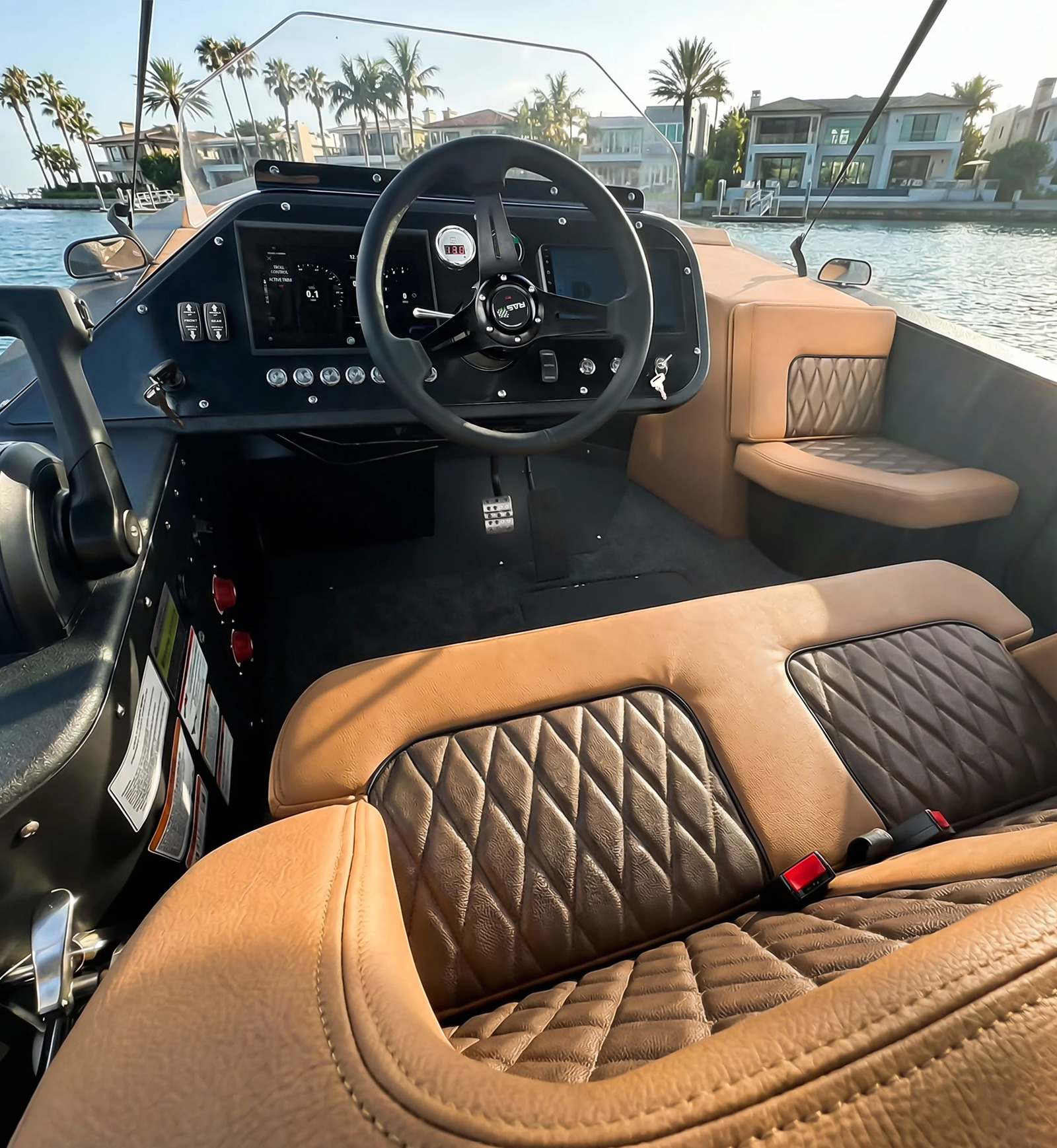WaterCar EV cockpit with steering wheel, digital displays and tan upholstered seating