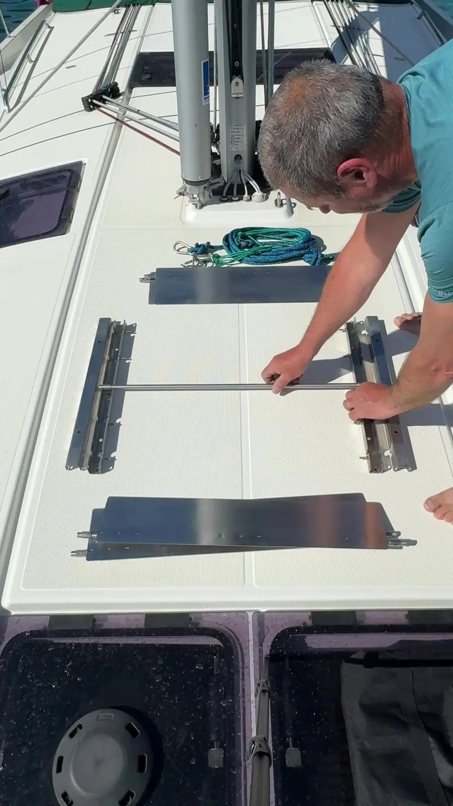 Person assembling the Wobbelstopper stainless-steel frame and flaps on a sailboat deck